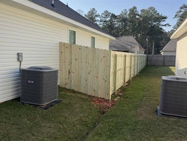 New treated pine privacy fence between neighboring homes