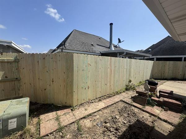 Treated pine privacy fence wrapping a patio corner