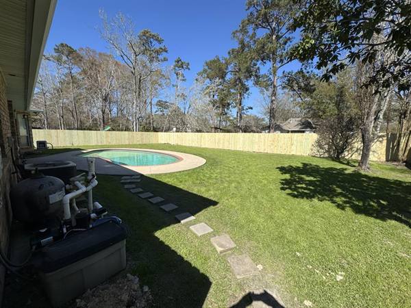 Treated pine privacy fence enclosing a backyard pool