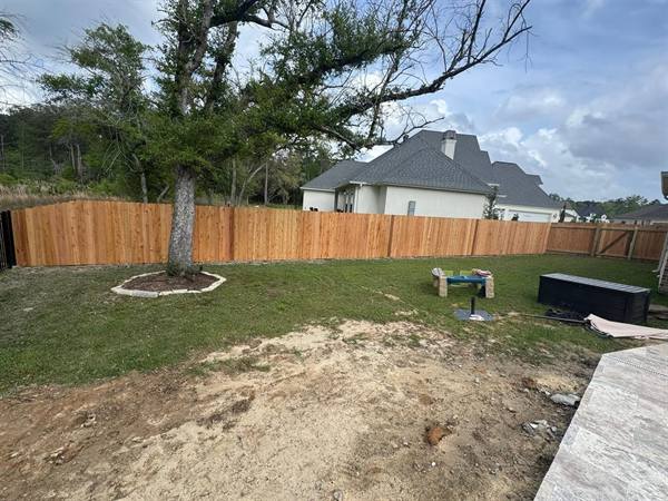 Cedar privacy fence around a new-construction backyard