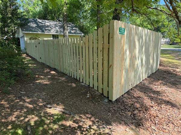 Shadowbox picket fence wrapping a shaded corner lot