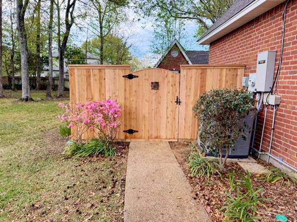 Arched cedar walk gate with decorative medallion
