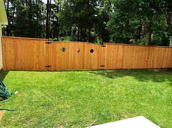 Cedar fence and gate with round porthole accents
