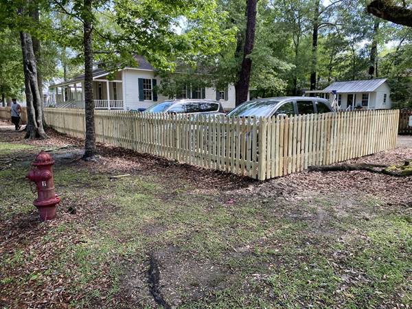 Treated pine picket fence at a corner lot