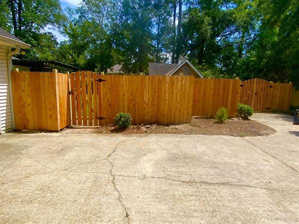 Cedar privacy fence and walk gate along a driveway