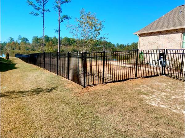 Black aluminum fence at a waterfront backyard